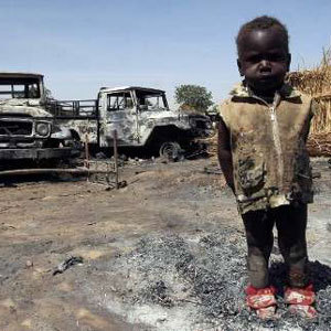 Un enfant derrière un paysage d'arrière plan dévasté par la guerre. Crédits photos : Sources