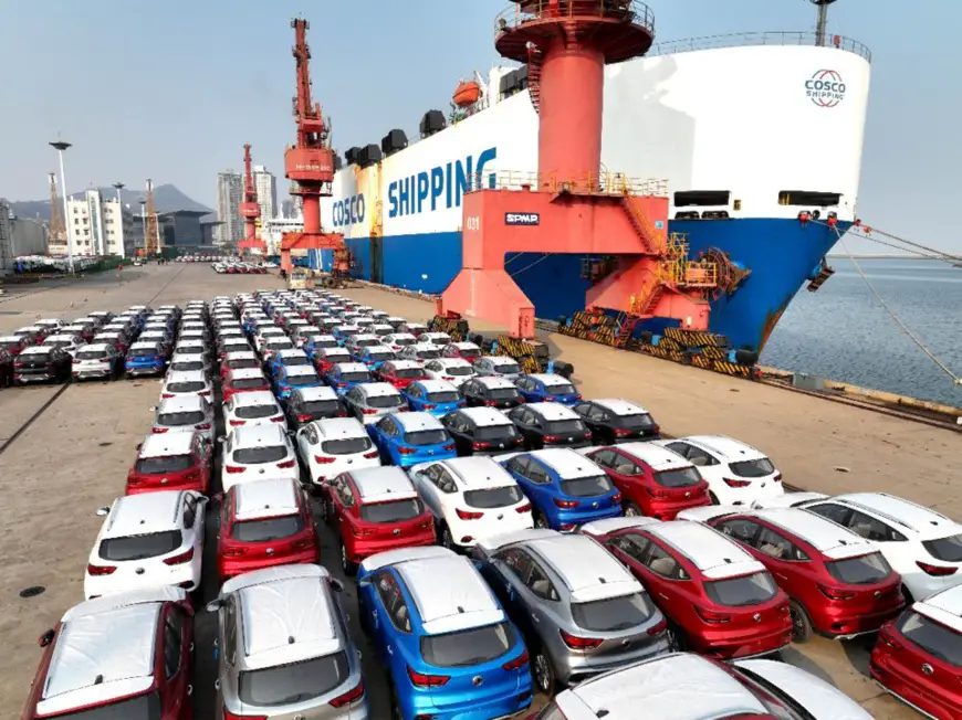 Vehicles are being loaded onto an oceangoing roll-on-roll-off ship for exportation at a terminal in Lianyungang, east China’s Jiangsu province, Jan. 3, 2022. (Photo by Wang Chun/People’s Daily)