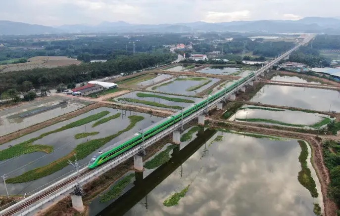 A bullet train runs on the China-Laos Railway in Jinghong, southwest China's Yunnan province. (Photo by Li Yunsheng/People's Daily Online)