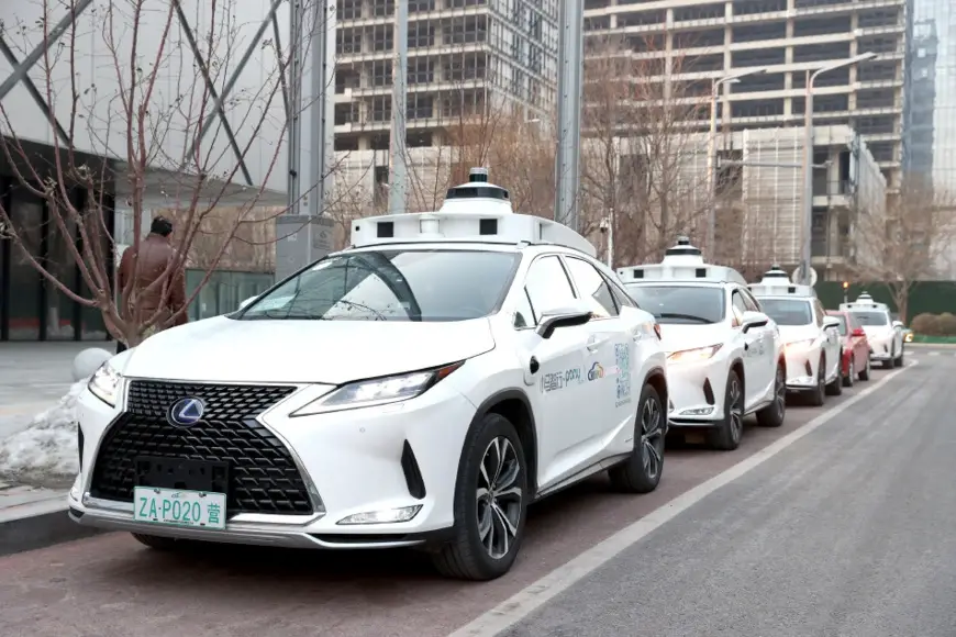 Photo shows autonomous vehicles on a street of Beijing Economic-Technological Development Area. (Photo by Wu Jiang)