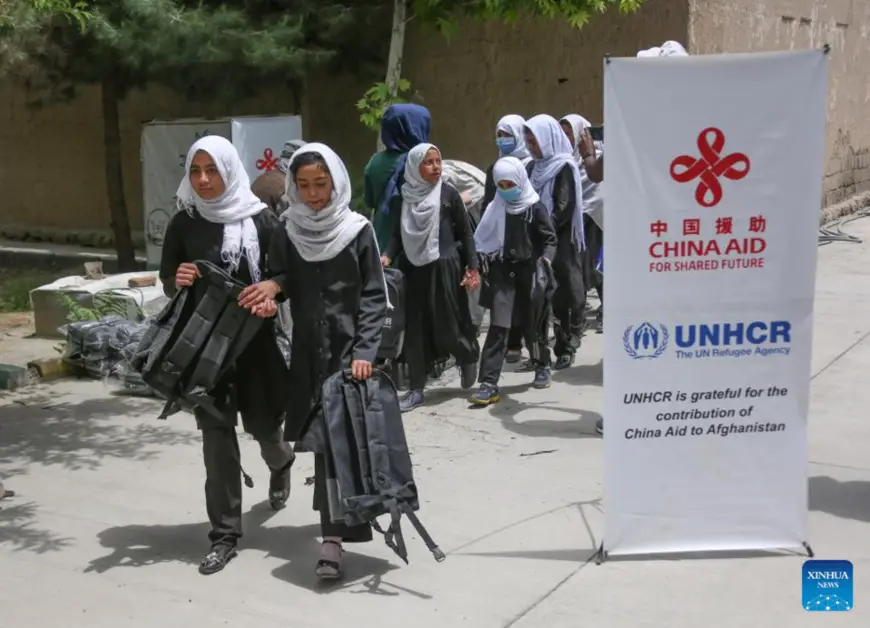 Afghan school children receive backpacks provided by China's South-South Cooperation Assistance Fund in cooperation with the United Nations Refugee Agency (UNHCR) in Kabul, Afghanistan, May 9, 2022. A batch of humanitarian supplies, provided by China's South-South Cooperation Assistance Fund in cooperation with the United Nations Refugee Agency (UNHCR), have been distributed in Afghanistan on Monday. (Photo by Saifurahman Safi/Xinhua)