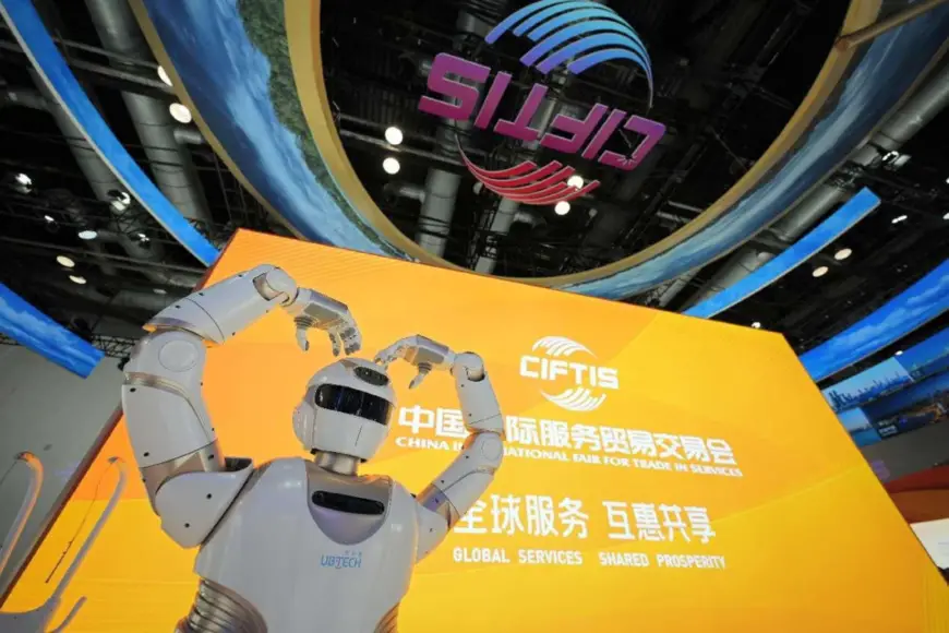 An intelligent robot makes an arm heart pose at the 2024 China International Fair for Trade in Services, Sept. 13, 2024. (Photo by Tang Ke/People's Daily Online)