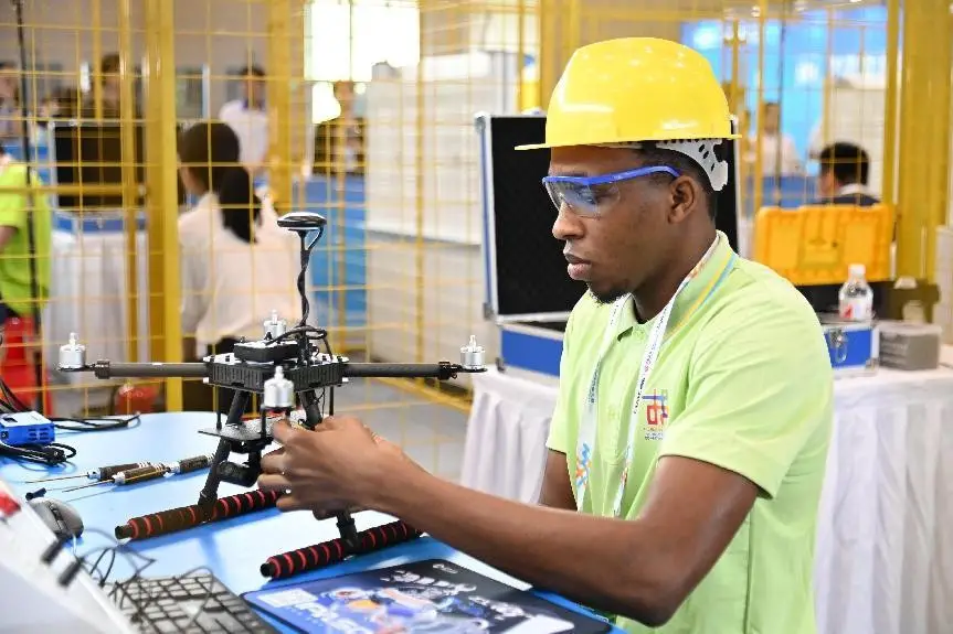 A competitor competes in drone assembly and troubleshooting during the second Belt and Road International Skills Competition at the Chongqing International Expo Center, southwest China's Chongqing municipality, June 25, 2024. (Photo by Sun Kaifang/People's Daily Online)