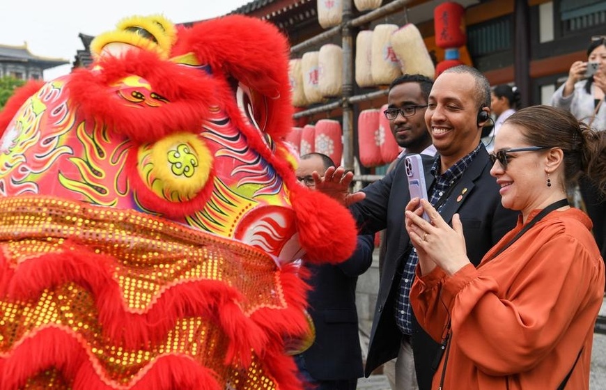 Members of a delegation of diplomatic envoys, agency representatives and journalists from Latin American and Caribbean countries visit an ancient town in Xiangyang, central China's Hubei Province, April 22, 2024. (Xinhua/Du Zixuan)