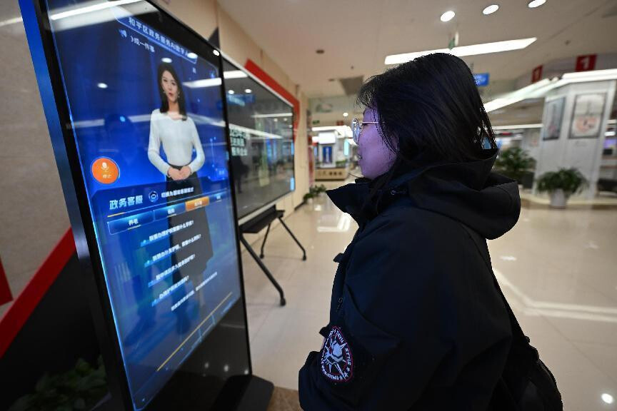 At a government service center in Shenyang, northeast China's Liaoning province, a woman interacts with an AI-driven service terminal designed to streamline administrative processes. (Photo by Zhao Jingdong/People's Daily Online)