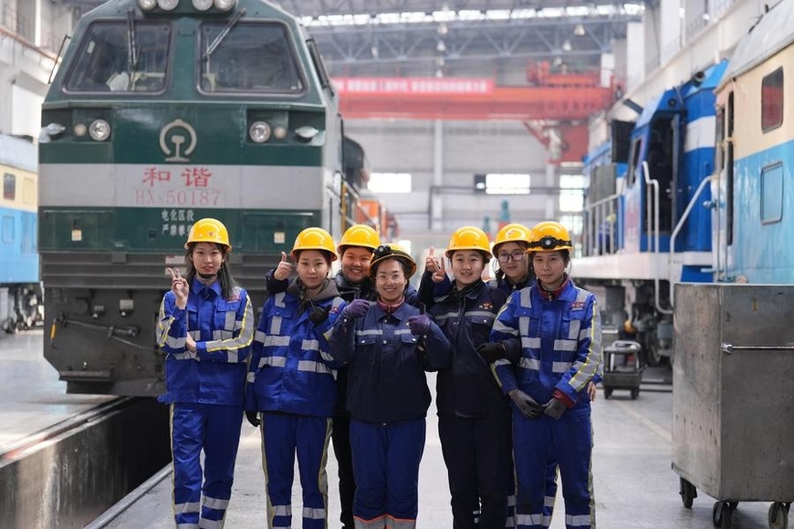 Members of a female maintenance team pose for a group photo at a depot of China Railway Harbin Group Co., Ltd. in Harbin, northeast China's Heilongjiang Province, March 6, 2025. (Xinhua/Wang Song)