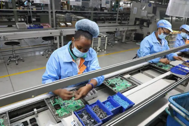 Local employees assemble motors in a workshop in the Hisense South Africa Industrial Park. (Photo by Zou Song/People's Daily)