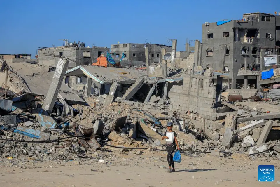 A girl walks past destroyed buildings in the southern Gaza Strip city of Khan Younis, on July 17, 2024. During the past 24 hours, the Israeli military killed 81 people and wounded 198 others, bringing the total death toll to 38,794 and injuries to 89,364 since the Palestinian-Israeli conflict broke out in early October 2023, Gaza-based health authorities said in a statement on Wednesday. (Photo by Rizek Abdeljawad/Xinhua)