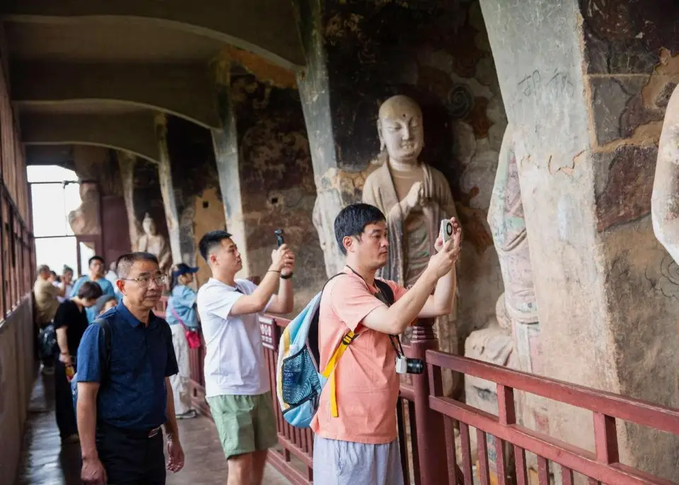 Tourists visit the Maiji Mountain Grottoes in Tianshui, northwest China's Gansu province. (Photo by Wang Wensuo/People's Daily Online)