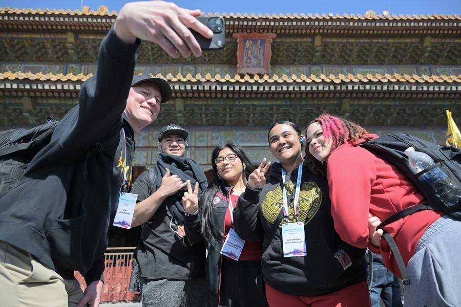 Members of a delegation of high school students from the U.S. state of Washington pose for a photo in front of the Qianqing Gong, or the Palace of Heavenly Purity, at the Palace Museum in Beijing, capital of China, March 19, 2024. (Xinhua/Li Xin)